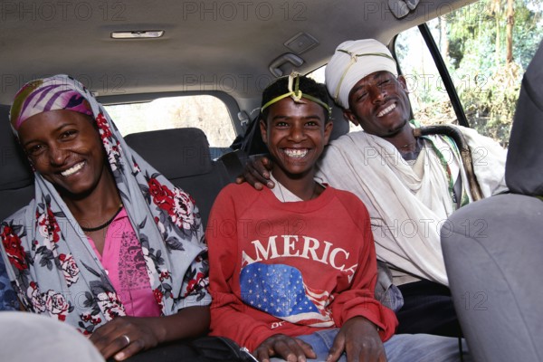 Three happy people in a Landcruiser in the Lasta Mountains. Modernity and tradition combined,