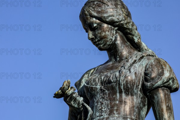 Detailed view of the Änchen von Tharau sculpture against a blue sky in Klaipeda, Klaipeda, Memel,