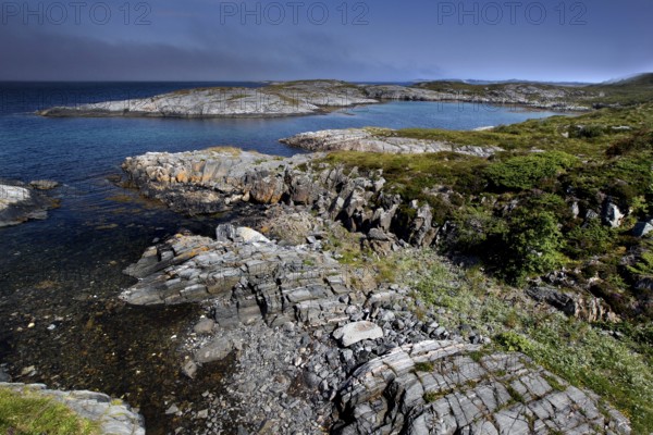 Rugged rocky coast with views from Eldhusøya across the sea near Lyngholmen, Atlanterhavsveien,
