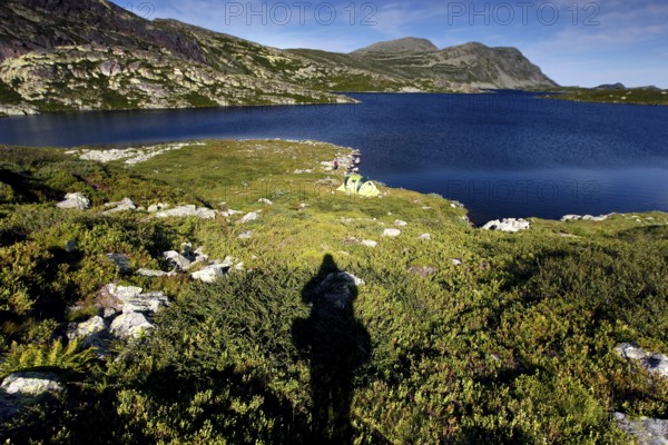 Tranquil seascape with long shadows in pristine nature, Hardangervidda, Gausdal, Norway