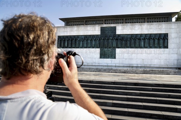 Martyr memorial with a photographer in the foreground, steps leading to the impressive building,