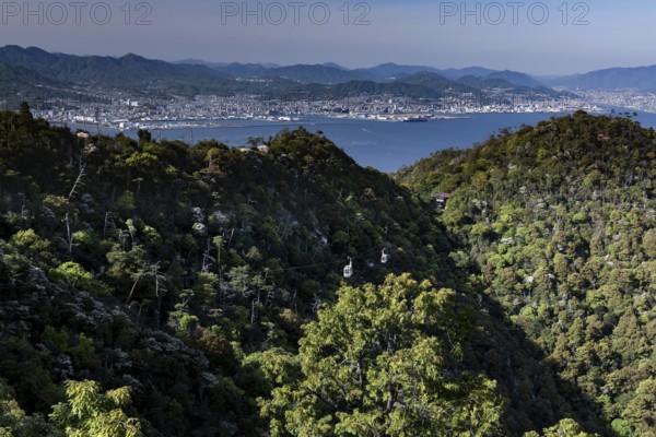 View of the forests and coastal landscape from Mount Misen with a view of Hiroshima, Miyajima,