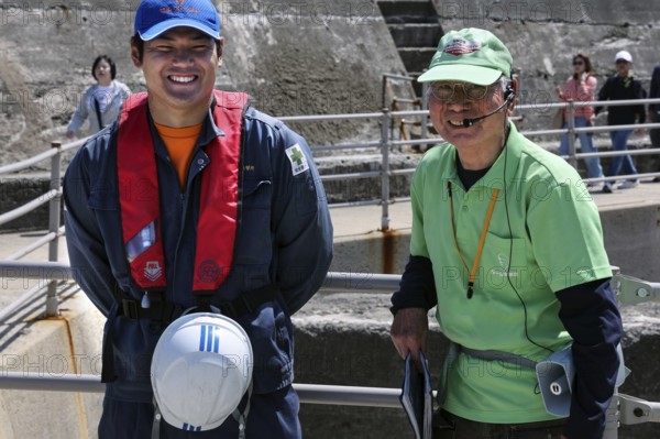 Two friendly guides during a shore trip on the deserted island of Gunkanjima, Nagasaki, Kyushu,
