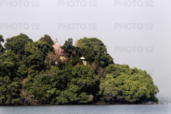 Wooded island in Lake Tana surrounded by calm water, zero