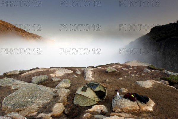 Single tent in fog on a rocky plateau near Kjeragbolten, Lysefjord, Rogaland, Norway