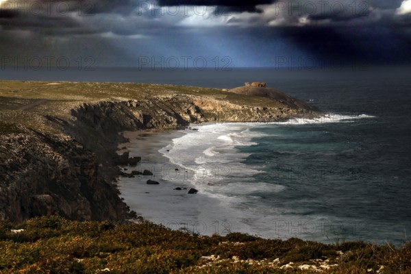 The dramatic coastline of Cape du Couedic with strong swell under dark skies, Kangaroo Island,
