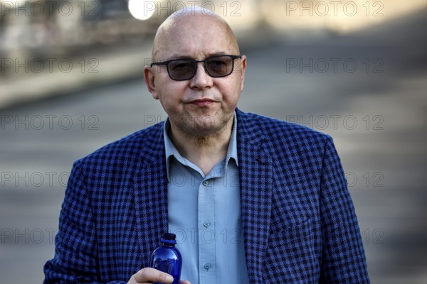 Man wearing checkered suit and sunglasses walks on the street in Tallinn, Tallinn, South Alinn,