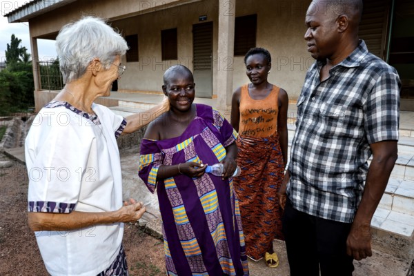 Staff and patients at CI Korhogo talking outdoors, Korhogo, CI, Côte d'Ivoire