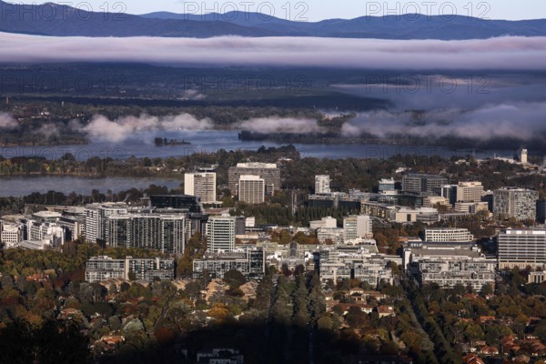 Overview of Mount Ainslie Lookout on Canberra amid surrounding mountains and morning light,