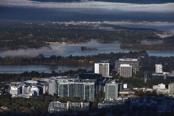 View of Canberra CBD from Mount Ainslie Lookout in the morning with fog fields over the lake,
