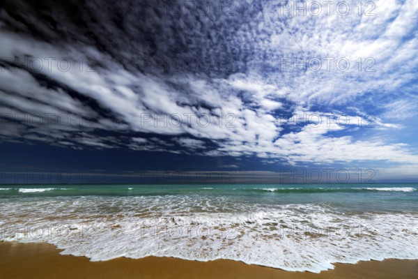 Dynamic cloud formations over the turquoise water of Cable Beach, Broome, Western Australia,