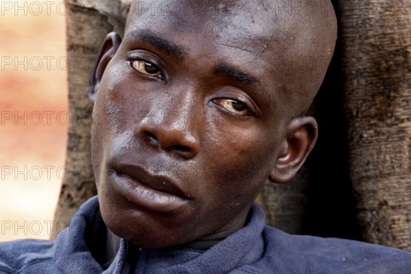 Close-up of an exhausted man outdoors in Bouaké. He seems emotionally burdened, Bouaké, Saint