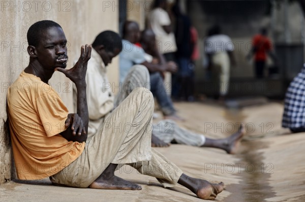 Patients sit on the wall of male psychiatry in quiet moments, Bouaké, Nimbo, Côte d'Ivoire