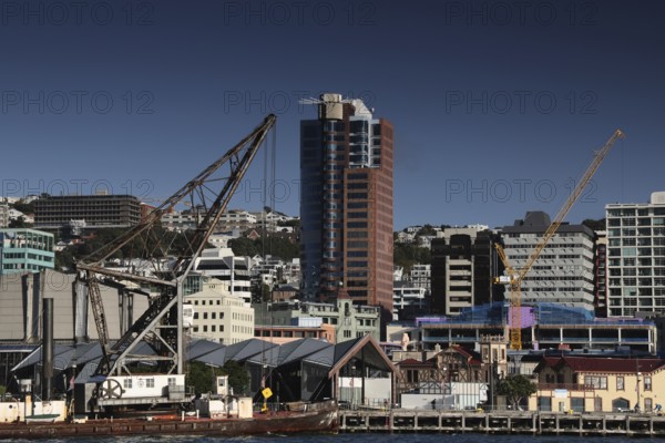Industrial crane next to modern urban architecture on Wellington Waterfront, Wellington, New