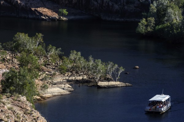 Boating on calm river between rocky landscape at Pat's Lookout in Nitmiluk National Park, Nitmiluk