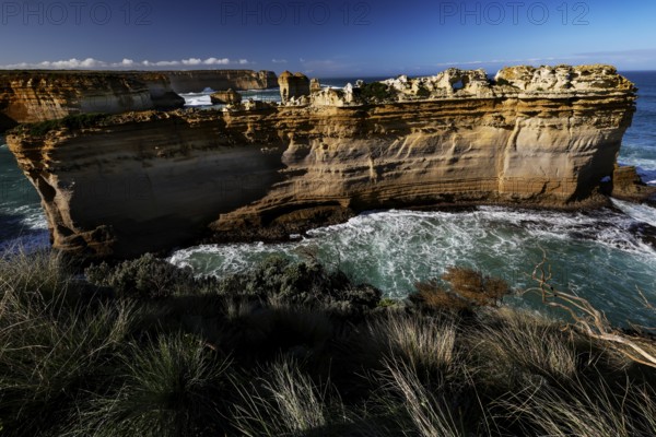 The impressive rock formation The Razorback on the Great Ocean Road surrounded by waves, Great