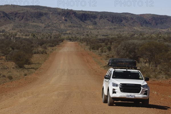 Off-road vehicle on lonely road of Mereenie Loop Road, Mereenie Loop Road, Northern Territory,