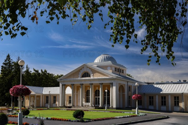 Elegant spa and hotel building in classical style with colonnades against a blue sky, Pärnu, Pärnu
