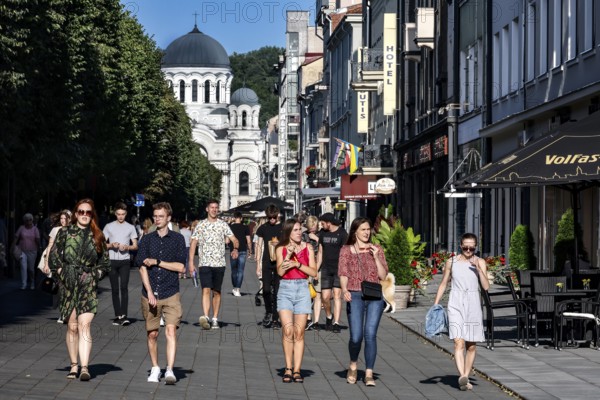 Laisves aleja in Kaunas with passers-by and the Church of Archangel Michael in the background,