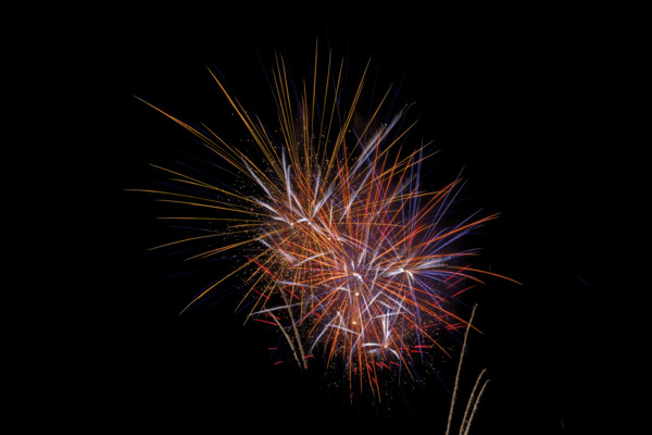 Fireworks in the night sky on New Year's Eve. Bad Salzschlirf, Hessen, Germany