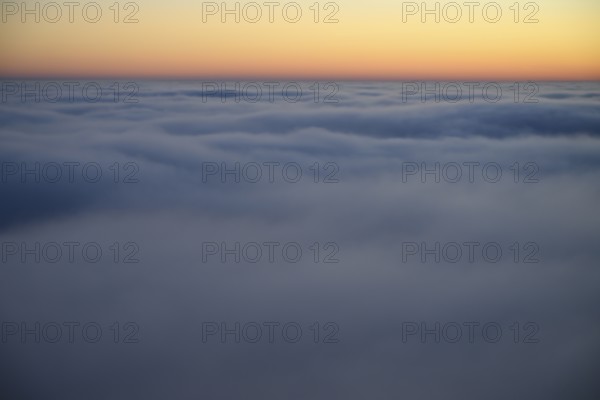 Soft morning clouds in pastel colors over a calm horizon in the Teutoburg Forest, Steinegge