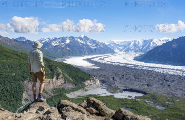 Young man enjoying the view, view of impressive mountain landscape with Matanuska glacier and