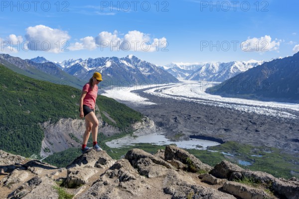 Young woman enjoying the view, view of impressive mountain landscape with Matanuska glacier and