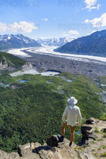 Young man enjoying the view, view of impressive mountain landscape with Matanuska glacier and
