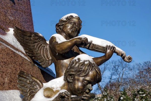 An angel playing the violin, figure at the Felix Mendessohn Bartholdy monument in winter with snow,