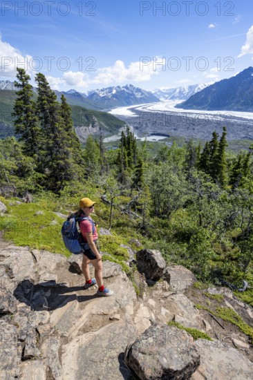 Young woman enjoying the view, view of impressive mountain landscape with Matanuska glacier and