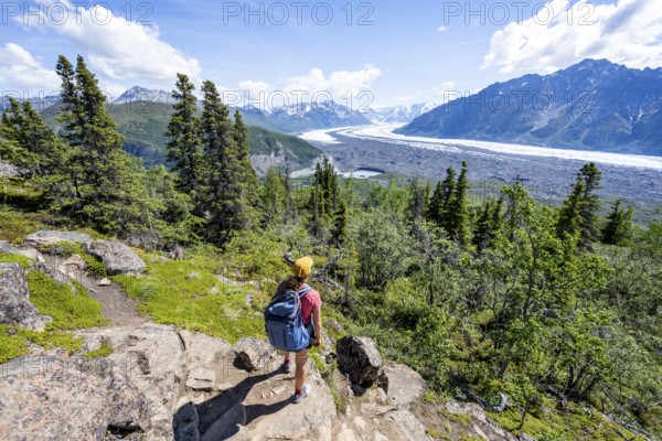 Young woman enjoying the view, view of impressive mountain landscape with Matanuska glacier and