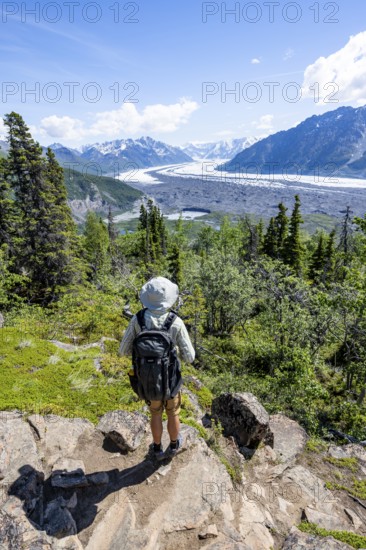 Young man enjoying the view, view of impressive mountain landscape with Matanuska glacier and