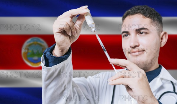 Doctor holding syringe on Costa Rica flag background. Medical professional holding syringe with