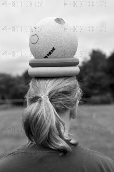 Person with ball and wrestling on head, environment in nature, sports and fun Olympics sports
