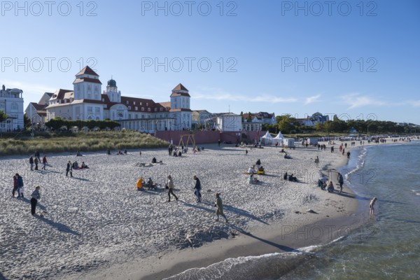 Tourists on the beach in autumn, spa hotel, Binz, seaside resort, Rügen island, Baltic Sea,
