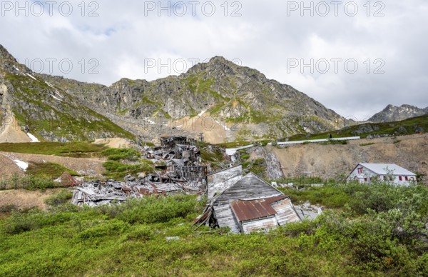 Crumbling buildings of the former Gold Mine Independence Mine in mountainous landscape,