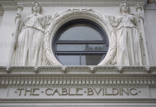 Two female sculptures above the entrance to the historic Cable Building, built in 1894 in Beaux