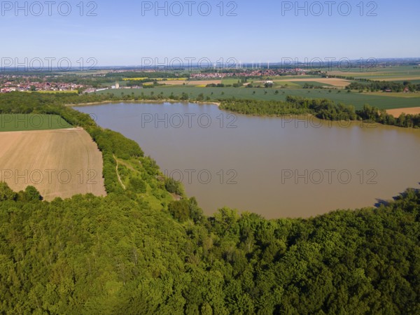 A quiet lake surrounded by forests and fields under clear skies, aerial view, Groß Bülten-Adenstedt
