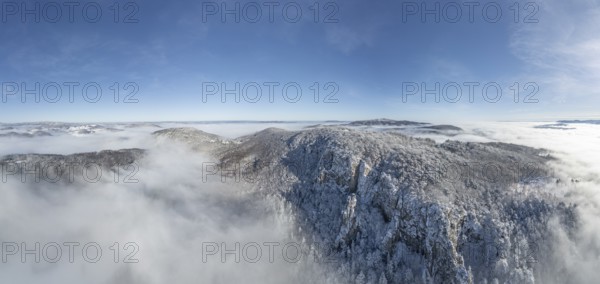 Aerial view of snowy stone walls and fog in the valley, Schwarzensee, Weissenbach an der Triesting,