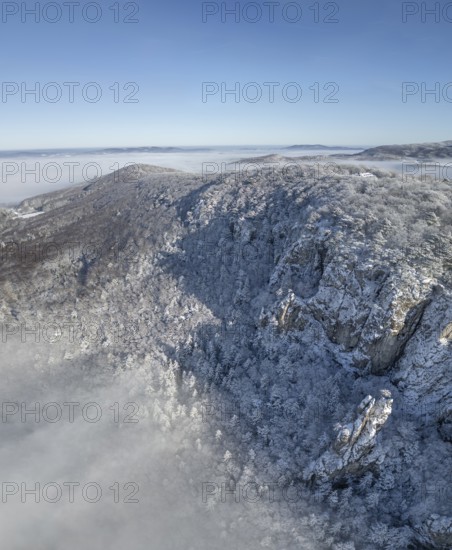 Aerial view of snowy stone walls and fog in the valley, Schwarzensee, Weissenbach an der Triesting,