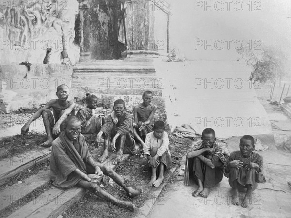 Group of leprosy patients. Sick beggars at the entrance to a temple in Rangoon. Leprosy (Hansen's