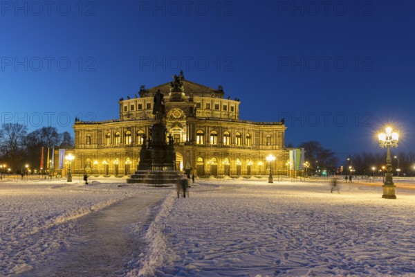 Illuminated Semper Opera House and Theatre Square with snow at dusk, Old Town of Dresden, Saxony,
