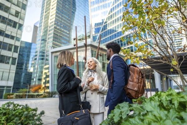 Diverse business professionals conversing and networking outdoors in a vibrant urban environment,