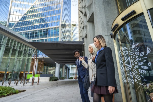 Diverse business colleagues walking and talking together, sharing ideas while navigating a modern