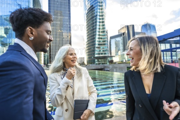 Diverse business professionals having a joyful outdoor conversation and networking session in a