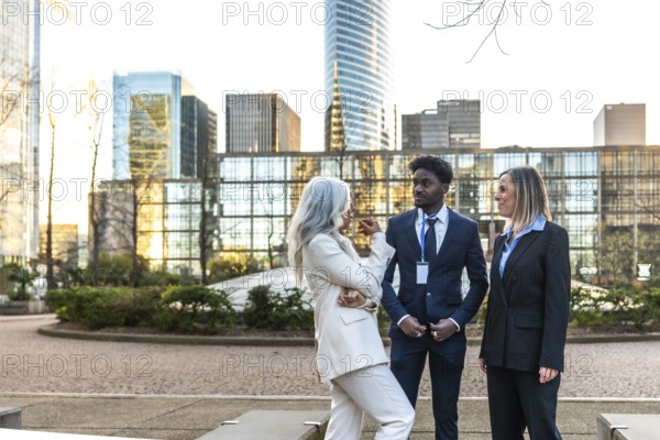 Diverse business professionals conducting an informal meeting and discussing ideas while standing