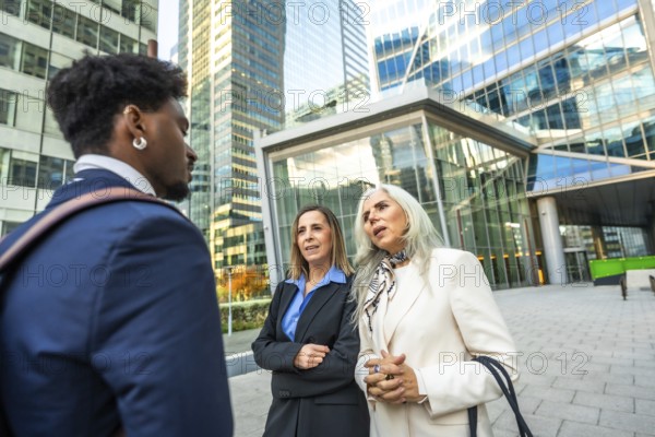 Diverse business professionals having an informal outdoor meeting, discussing ideas and