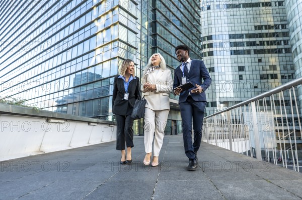 Three diverse business professionals. Including a young black man. A mature woman. And a young