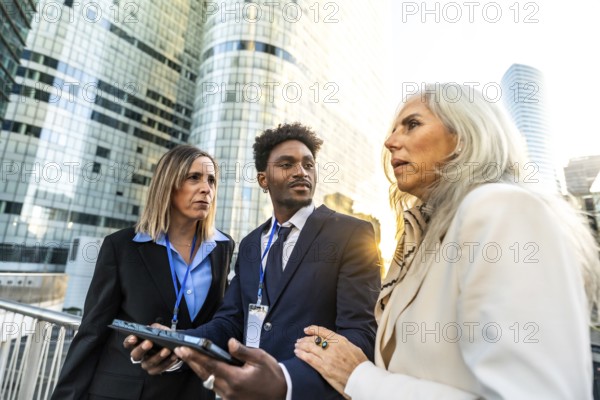 Diverse business professionals having an outdoor meeting, collaborating and discussing work,
