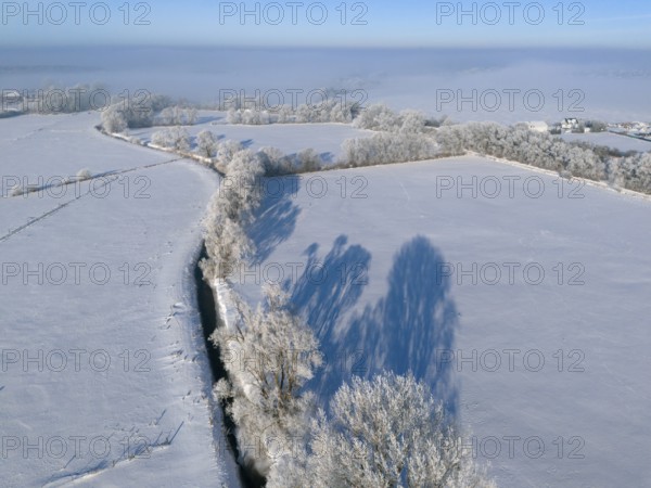Winter peace with snow-covered fields and frosty trees under a clear blue sky, Fuhse river, Bülten,